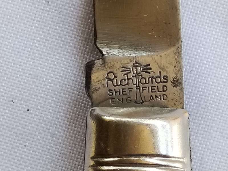 Three vintage pocket knifes two with animals and one union building