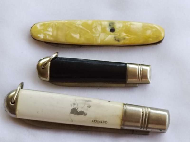 Three vintage pocket knifes two with animals and one union building
