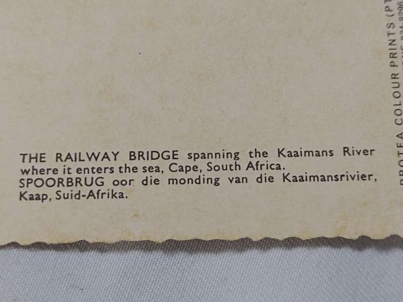 The Railway Bridge spanning the Kaaimans River where it enters the sea. Postcard.