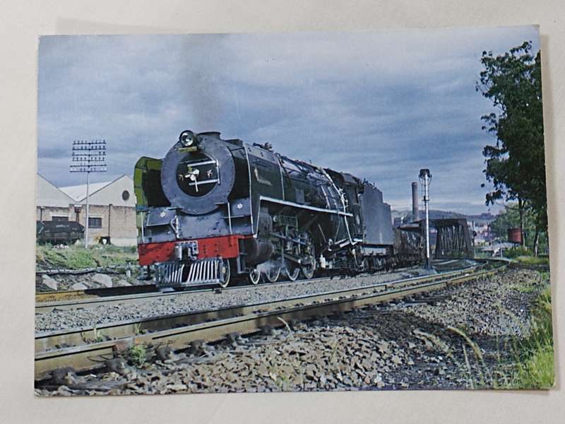 A Class 16E locomotive departing Bloemfontein postcard
