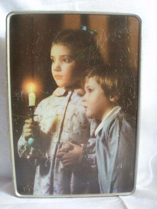 LOVELY TIN OF A BOY & GIRL HOLDING A CANDLE
