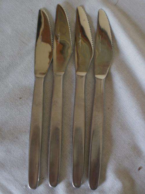 FOUR STAINLESS STEEL KNIVES