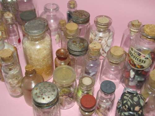 large lot of about 38 small glass bottles - some with labels, some with items inside