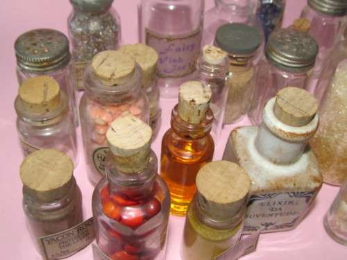 large lot of about 38 small glass bottles - some with labels, some with items inside