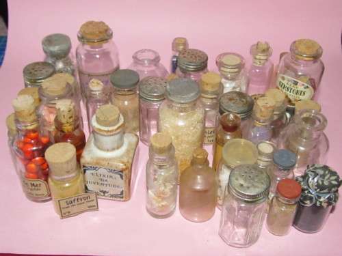 large lot of about 38 small glass bottles - some with labels, some with items inside