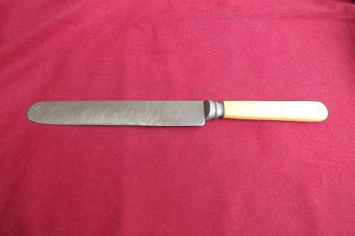 Vintage faux bone handle dinner knife made in Sheffield England.Good condition