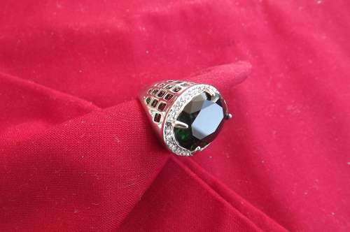 Bulky rhodium plated ring with oval emerald green stone.See scans for design.New condition