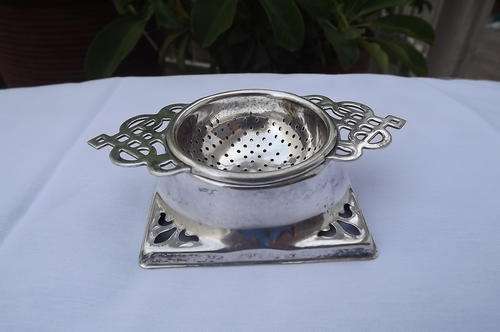 Antique tea strainer on stand EPNS - made in England