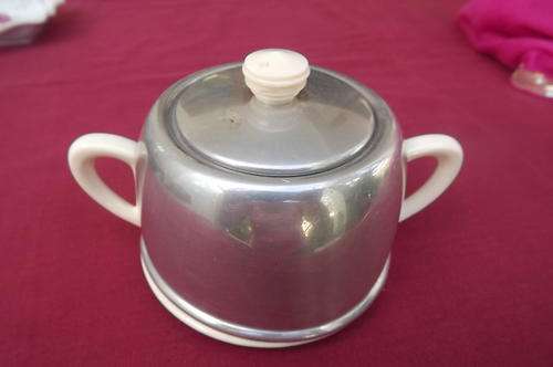 Small porcelain pot with metal cover and lid