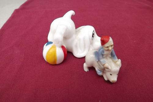 Lot of 2 Small Porcelain Trinkets - dog with ball and man on pig - height dog 4cm, man 3.5cm