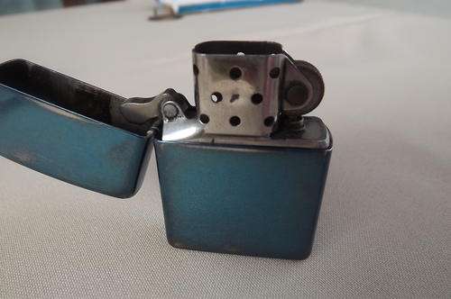 Zippo Lighter in Shiny Turquoise Colour -Cover at back is printed E Zippo 04 Bradford PA made in USA