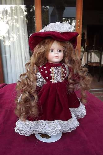 Beautiful porcelain doll with light brown locks,red velvet dress with hat,pants and shoes.27 cm Tall