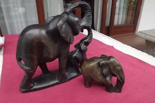 Lot of 2 soapstone ornaments.One large elephant with baby (ear chipped)and small elephant 8x7cm