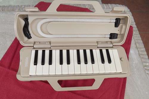 Small portable organ.Insert pipe at side and by blowing you can play on it.Very good condition