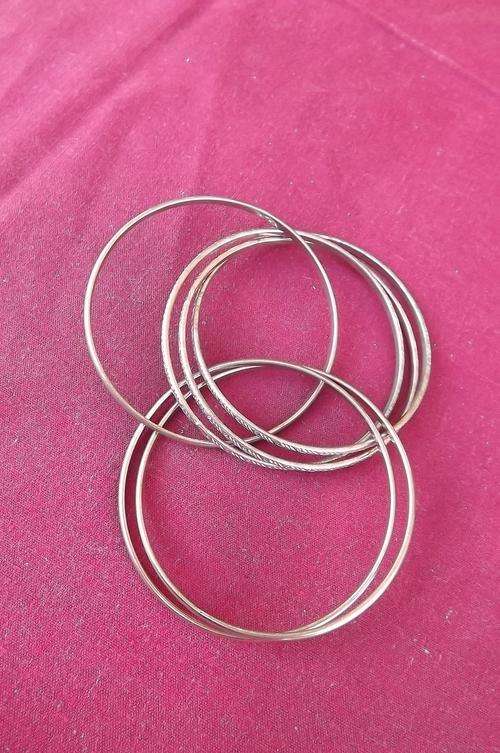 Entangled set of metal bangles 7.2 cm diameter.Copper & brass