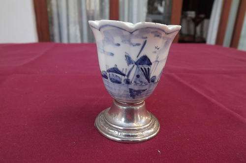 Cute delft look egg cup on chrome plated foot.Small chips on rim