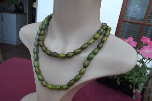 Long green wooden bead necklace. Can turn around neck or wear as 1 string. New.