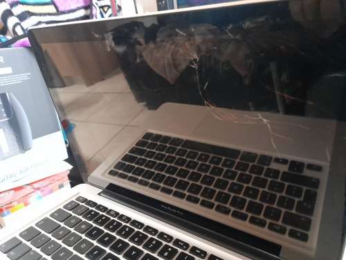 **MONTH END MADNESS*APPLE MAC BOOK PRO*NO CHARER NOT SURE SPECS*CRACKED SCREEN**