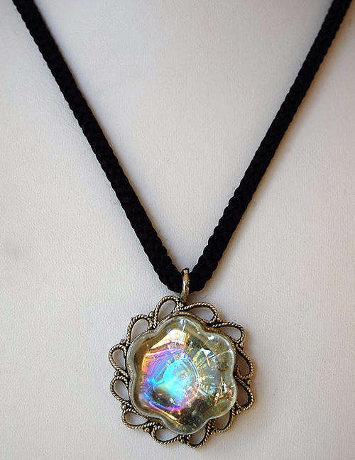 GLASS PENDANT IN ORNATE METAL SETTING