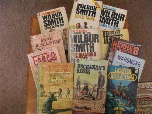 8 X WESTERNS AND 4 X WILBUR SMITH PAPERBACKS