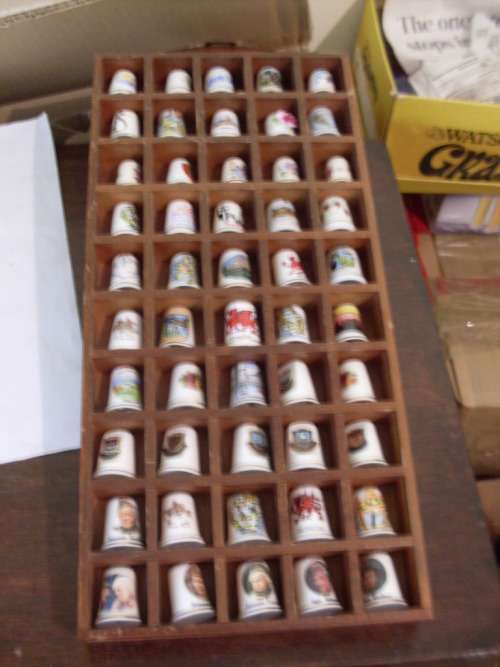 50 THIMBLES IN A WOODEN THIMBLE DISPLAY RACK