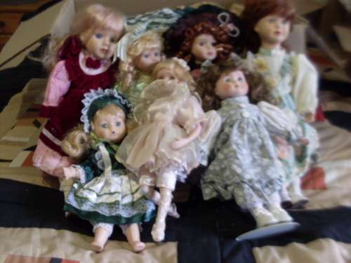7 FULLY DRESSED PRETTY PORCELAIN DOLLS