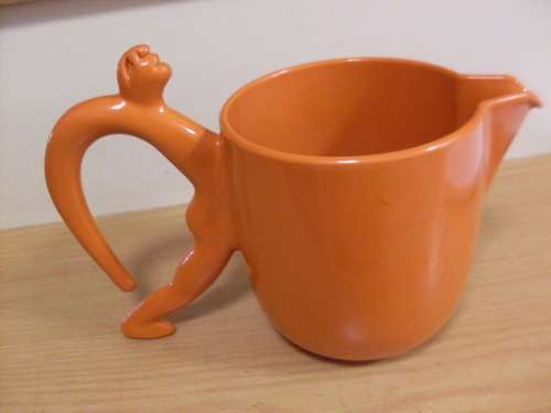 WOW....VERY RARE ORANGE ICE TEA JUG WITH MAN SHAPE FIGURE HANDLE BY CARROL BOYES