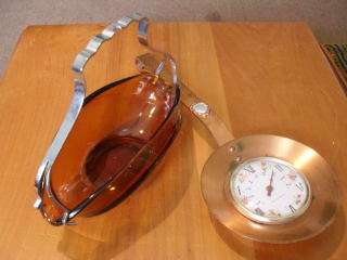 A THERMOMETER IN A COPPER SPOON SHAPE AND AN AMBER BOWL &METAL HANDLE