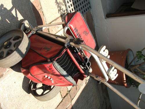 Red Gemini Plus golf cart - with rain cover