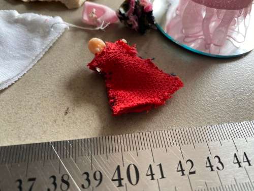 Cute mini baby crib with small doll on glass mirror and some clothes - very cute