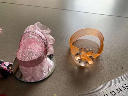 Cute mini baby crib with small doll on glass mirror and some clothes - very cute