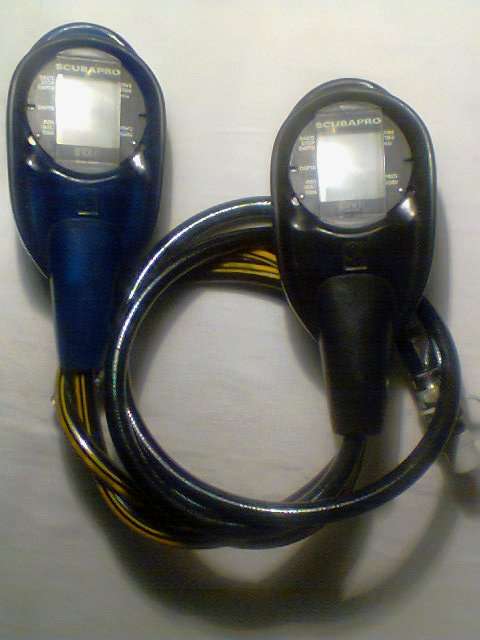 2 SCUBAPRO Diving Computers one Black which come's "on" & one Blue which Battery needs replacing.