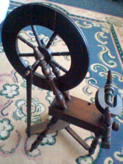 A SMALL SPINNING WHEEL , That Opperates by Foot Power.In Excelent Condition.