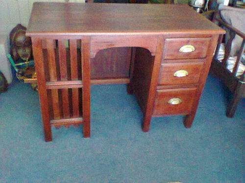 A Turn of the Century Teak Writing Desk with 3 Draws & Magizeen or Filling racks in excelent order.