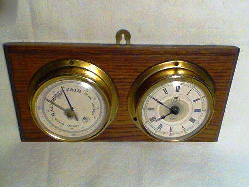 A Old Vintage Barometer & Quartz Clock Combo mounted in " Old English OAK  ". In Good Condition'