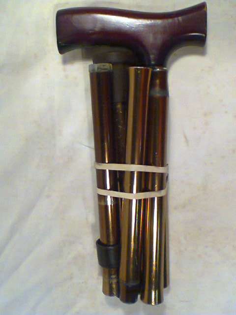 A Vintage Collapsible fold-up steel adjustable Walking Stick. Adjusts down from 945mm to 840mm