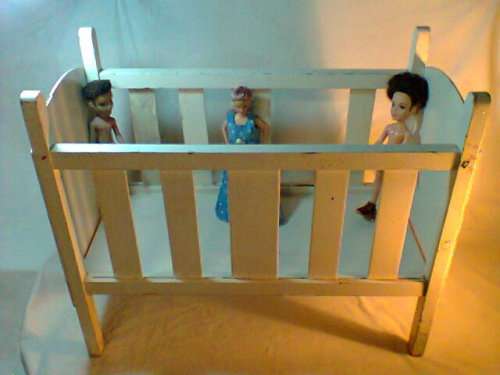A 60 year old Doll's play Cot for children to play with In Good Second used condition.
