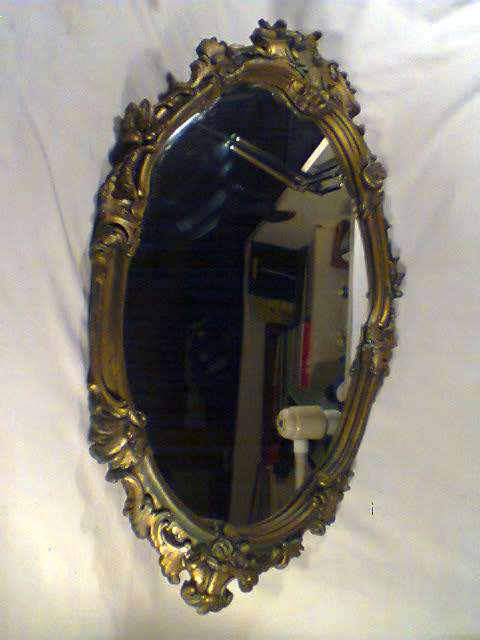 Over 50 years Old. With a lot of Beautiful patrons and scolops, bevelled Gold framed Oval Mirror