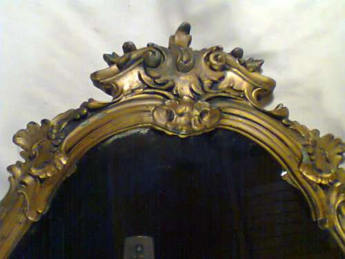 Over 50 years Old. With a lot of Beautiful patrons and scolops, bevelled Gold framed Oval Mirror