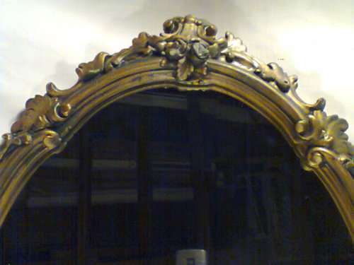 Over 50 years Old. With a lot of Beautiful patrons and scolops, bevelled Gold framed Oval Mirror