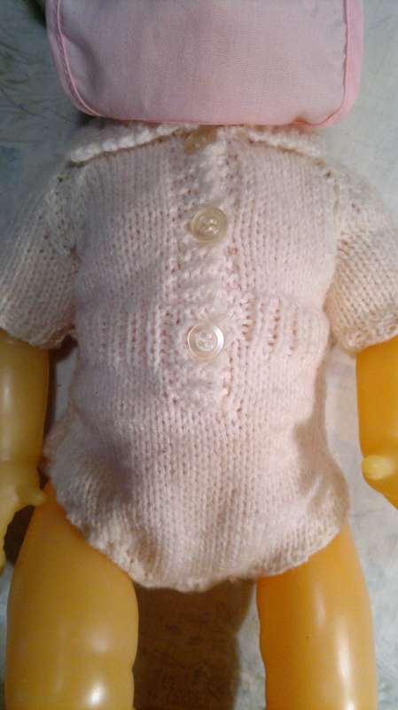 Collectible Wetting Doll with a Knitted Jump suit. All in good Order.