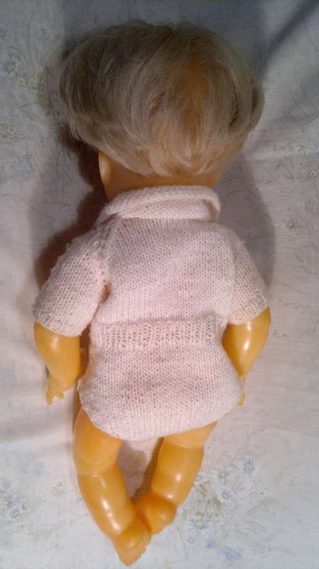 Collectible Wetting Doll with a Knitted Jump suit. All in good Order.