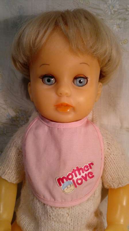 Collectible Wetting Doll with a Knitted Jump suit. All in good Order.