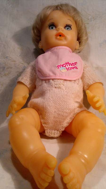 Collectible Wetting Doll with a Knitted Jump suit. All in good Order.