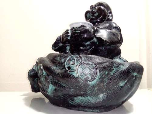 Large Green Buda with (We Think) ceramic?  bowl sitting on a money bag. In good condition.