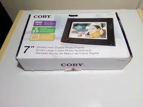 A `Coby` 7 ` Digital photo frame plug in and play with Instructions and Charger in box.