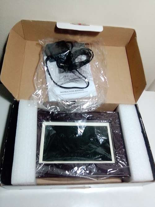 A `Coby` 7 ` Digital photo frame plug in and play with Instructions and Charger in box.