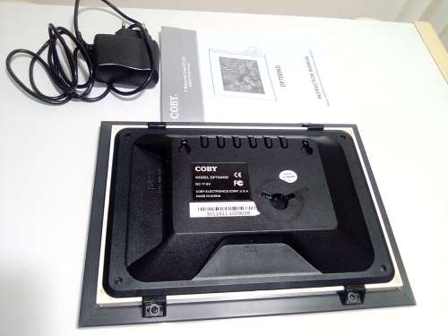 A `Coby` 7 ` Digital photo frame plug in and play with Instructions and Charger in box.