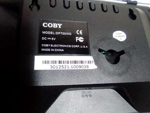 A `Coby` 7 ` Digital photo frame plug in and play with Instructions and Charger in box.