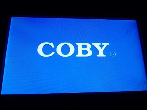 A `Coby` 7 ` Digital photo frame plug in and play with Instructions and Charger in box.